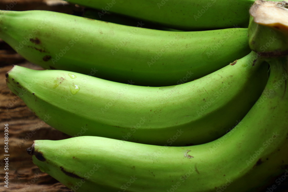 raw bananas on wooden background