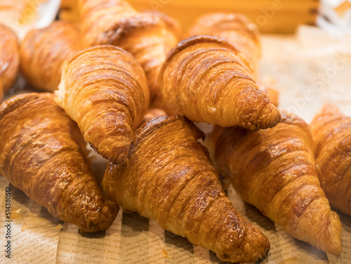Tasty croissants on the tray sellin in the bakery shop.
