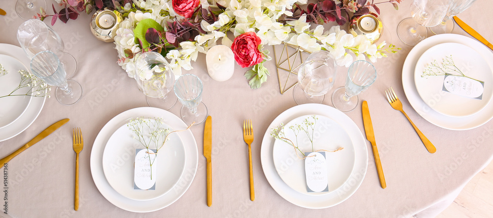 Beautiful wedding table setting with floral decor and candles Beautiful wedding table setting with floral decor and candles