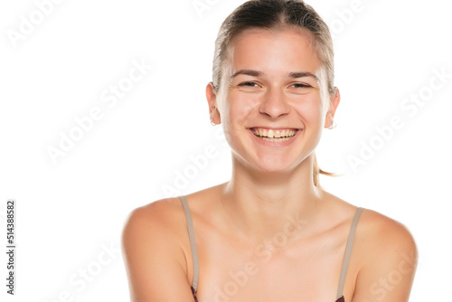 Portrait of smiling young woman without make up  isolated on white background.