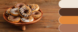 Stand with tasty donuts on wooden table. Different color patterns