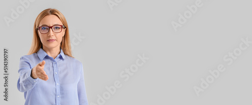Mature businesswoman giving...