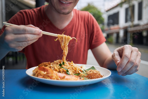 Photography Close-up of chopsticks with Pad Thai food
