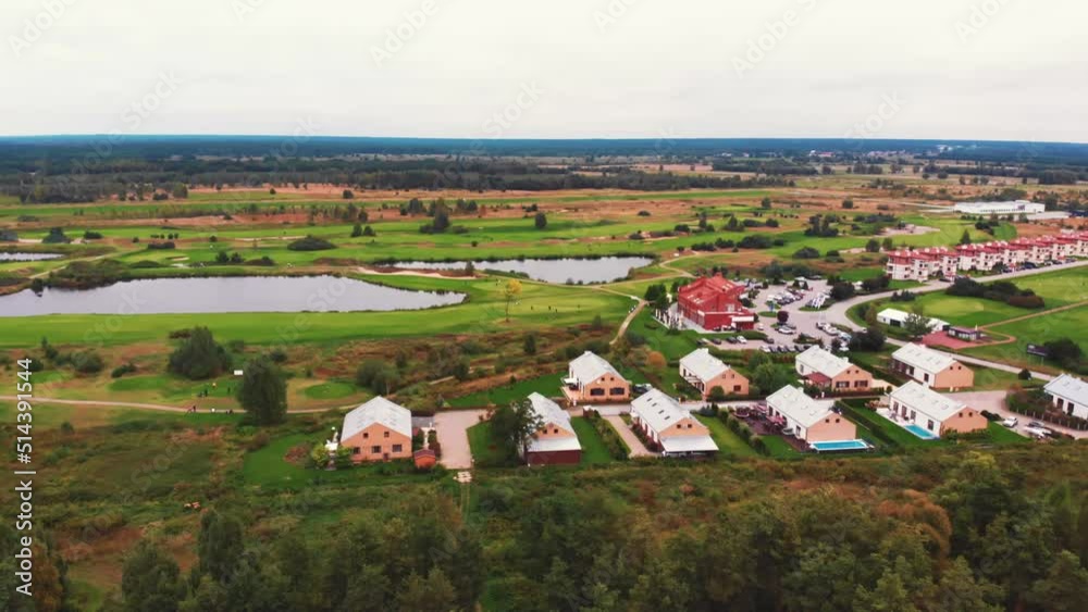 Drone shot of a beautiful peaceful green neighborhood with big houses, ponds, and forest. High quality 4k footage Drone shot of a beautiful peaceful green neighborhood with big houses, ponds, and forest. High quality 4k footage