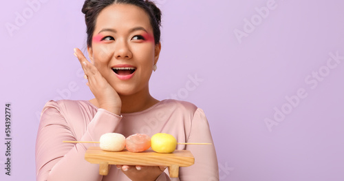 Happy Asian woman with tast...