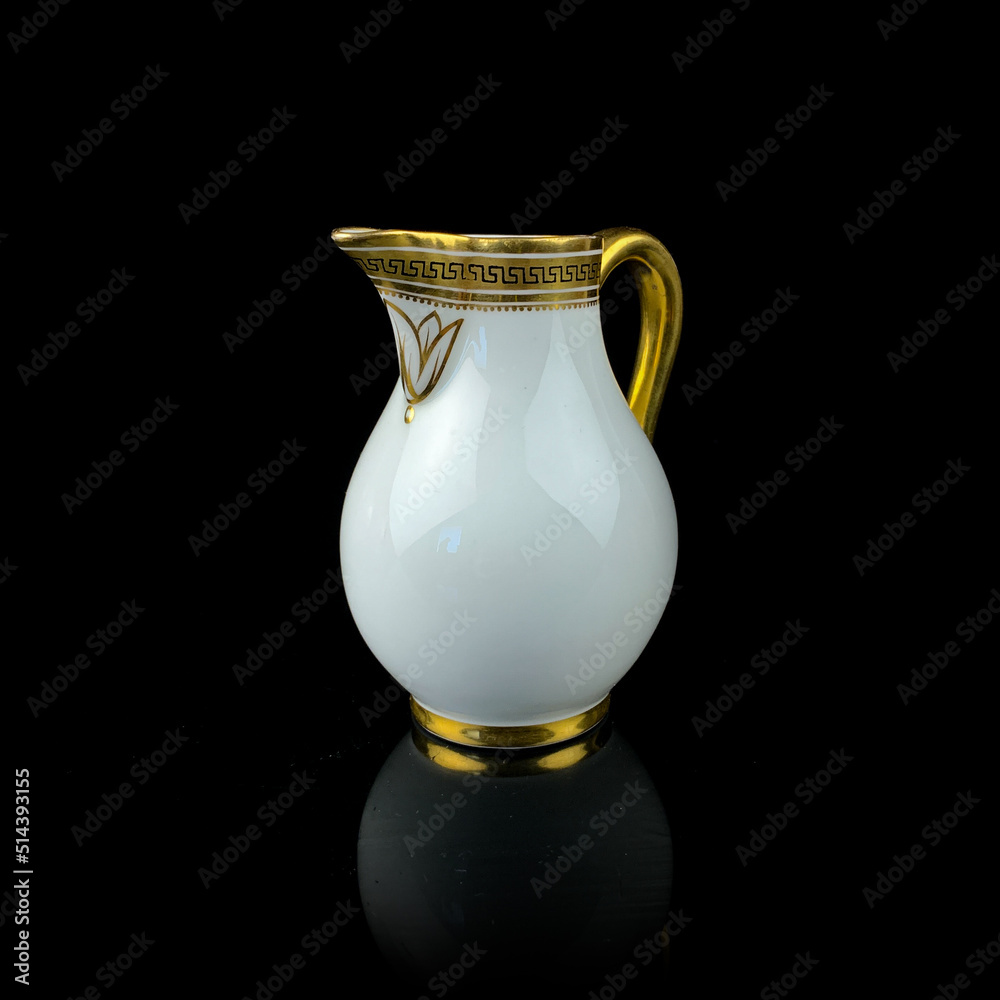 white antique milk jug with gold pattern. retro vessel for milk. coffee service. vintage gravy boat white antique milk jug with gold pattern. retro vessel for milk. coffee service. vintage gravy boat
