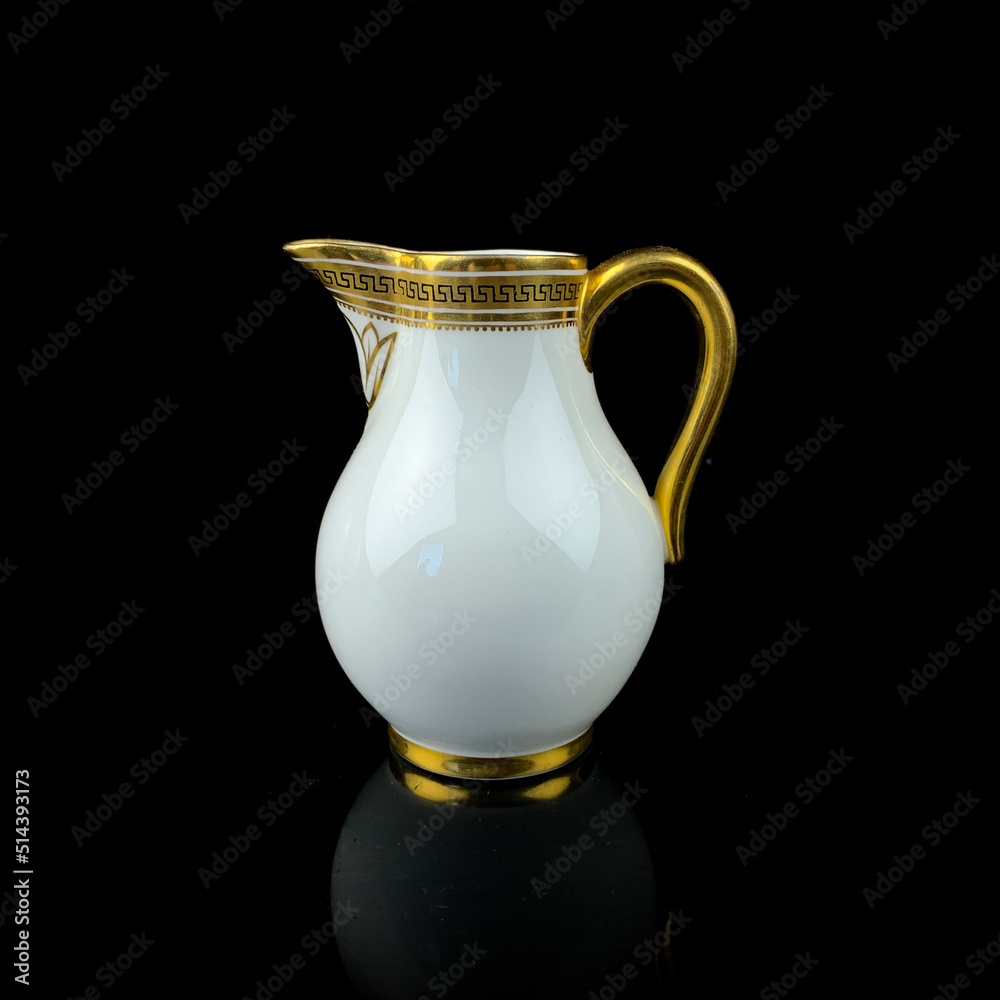 white antique milk jug with gold pattern. retro vessel for milk. coffee service. vintage gravy boat white antique milk jug with gold pattern. retro vessel for milk. coffee service. vintage gravy boat