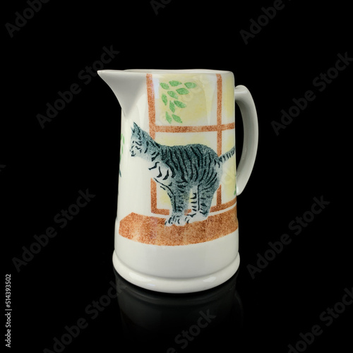 antique milk jug with a picture of a cat. retro vessel for milk. coffee service. vintage gravy boat