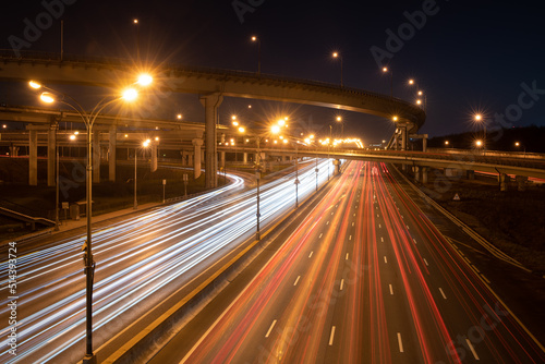 Modern highway at night with car light trails. Long exposure shot of road lights