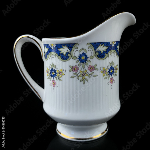 antique milk jug with floral pattern. retro vessel for milk. coffee service. vintage gravy boat