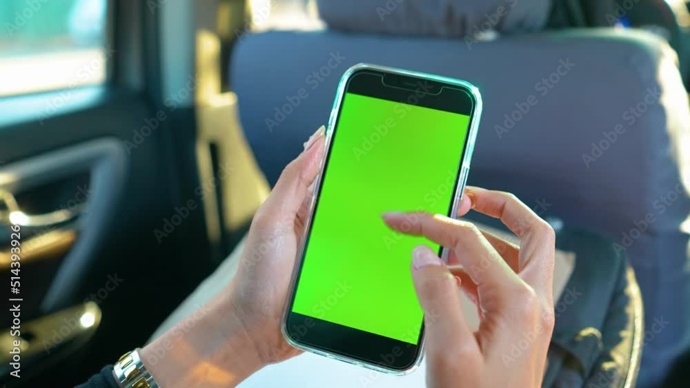 Woman Scrolling And Zooming In On Phone Green Screen Inside Car Daytime