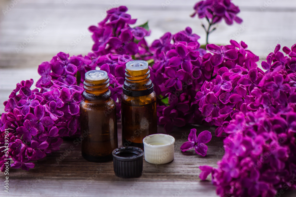 Lilac essential oil in a small bottle. Selective focus. Lilac essential oil in a small bottle. Selective focus.