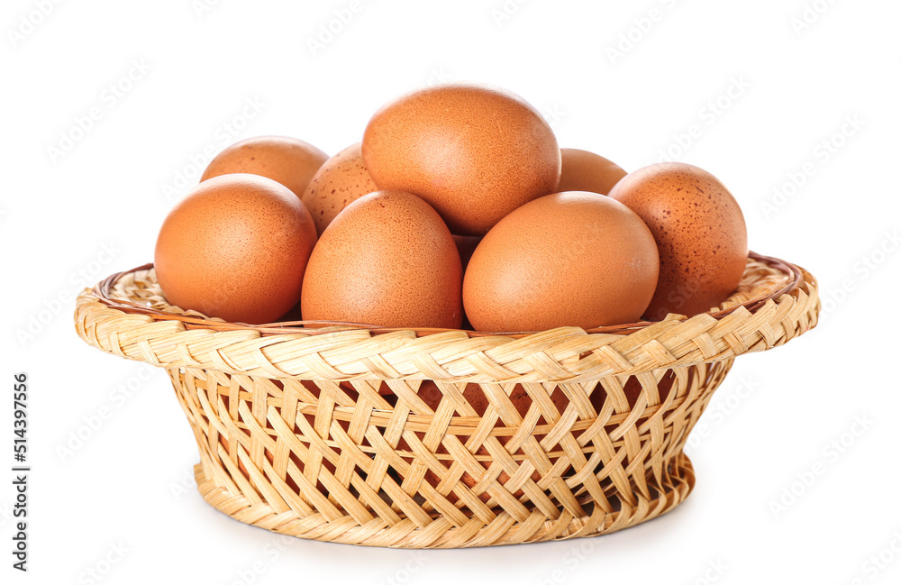 Wicker basket with brown chicken eggs on white background Wicker basket with brown chicken eggs on white background