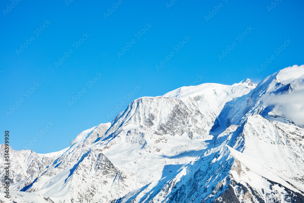 Peaks in snow Mont Blanc Alps mountains massif over blue sky