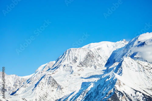 Peaks in snow Mont Blanc Alps mountains massif over blue sky © Sergey Novikov