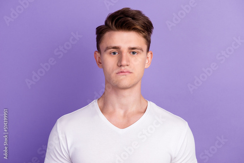 Portrait of serious good youngster man look in camera serious facial expression isolated violet bright color background