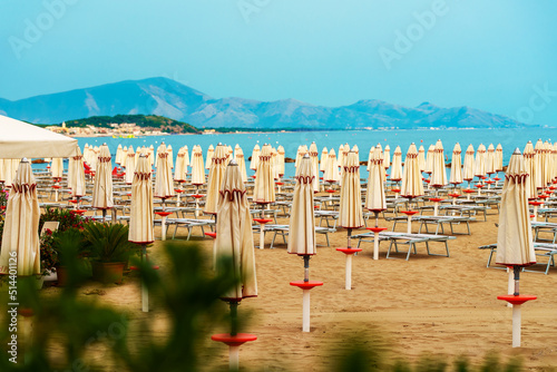 Sun loungers and umbrellas on the private beach. photo