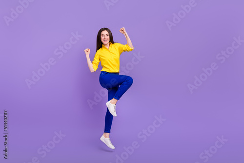 Full length body size view of attractive cheery girl jumping rejoicing good mood isolated over bright violet purple color background