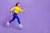 Full length body size view of attractive trendy cheery girl jumping running isolated over bright violet purple color background