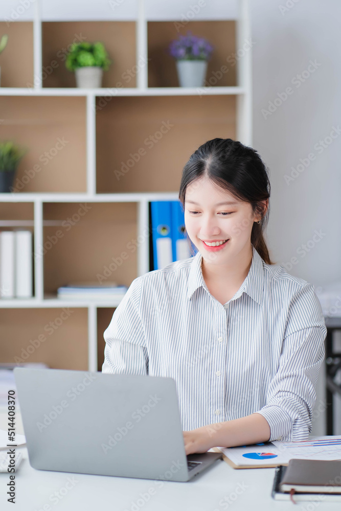 Young asian businesswoman beautiful charming smiling and talking on the mobile phone in the office Young asian businesswoman beautiful charming smiling and talking on the mobile phone in the office