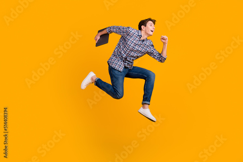 Full size photo of funky man jump use laptop search social media online wear casual style clothing isolated over bright background