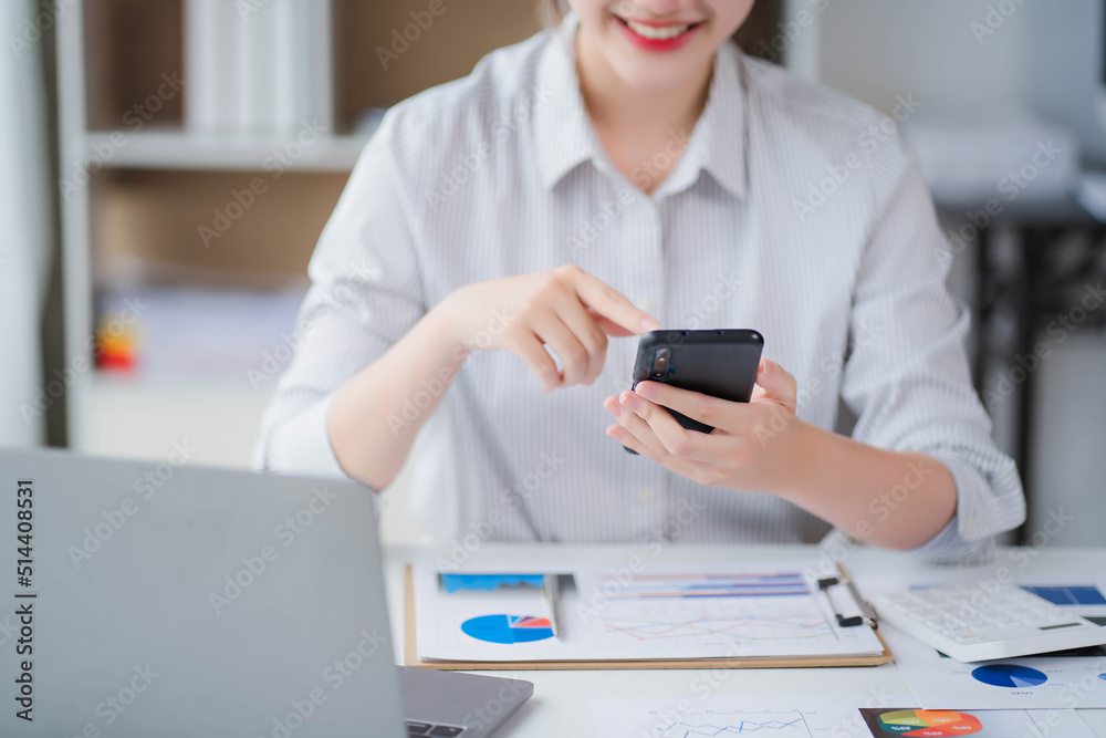 Young asian businesswoman beautiful charming smiling and talking on the mobile phone in the office Young asian businesswoman beautiful charming smiling and talking on the mobile phone in the office