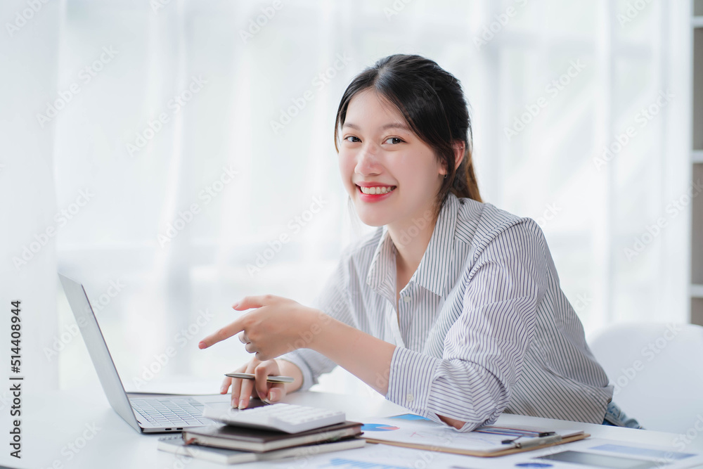 Young asian businesswoman beautiful charming smiling and talking on the mobile phone in the office Young asian businesswoman beautiful charming smiling and talking on the mobile phone in the office