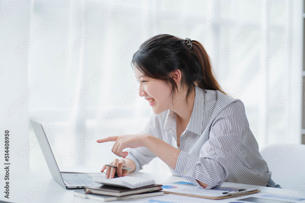 Young asian businesswoman beautiful charming smiling and talking on the mobile phone in the office Young asian businesswoman beautiful charming smiling and talking on the mobile phone in the office