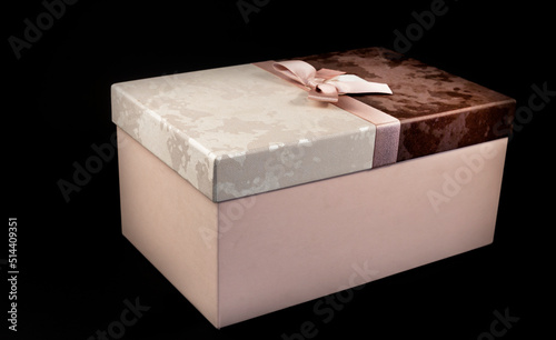 Black friday gift box with pink bow on black background. Copy space. Horizontal, banner, postcard
