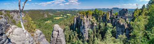 Obraz na plátně Panoramic over monumental Bastei sandstone pillars, rock formation and stacks surrounded by ancient forests at Kurort Rathen village in the national park Saxon Switzerland by Dresden, Saxony, Germany