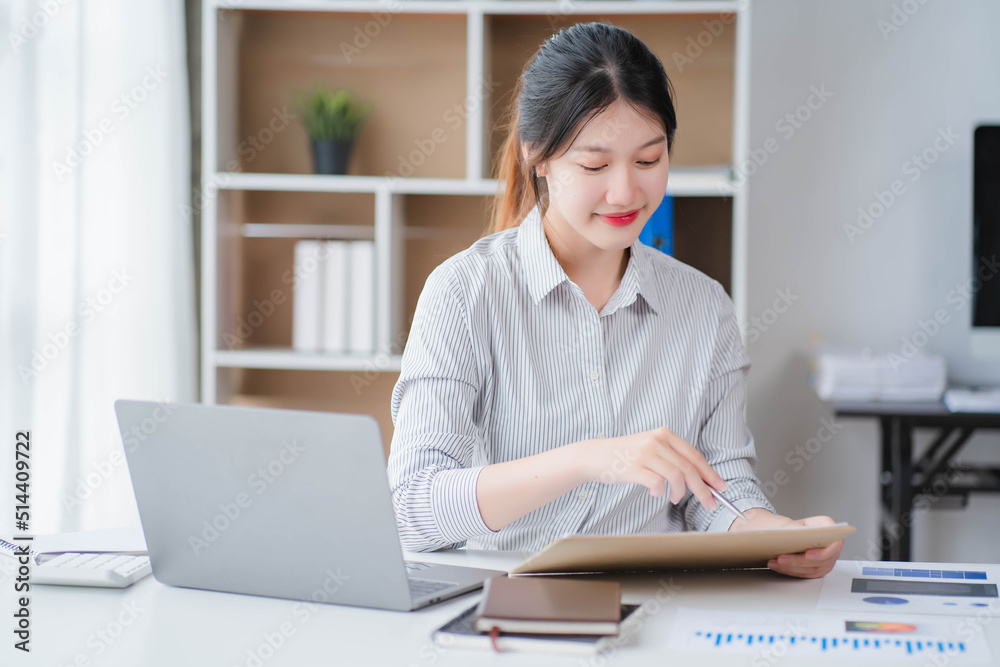 Young asian businesswoman beautiful charming smiling and talking on the mobile phone in the office Young asian businesswoman beautiful charming smiling and talking on the mobile phone in the office