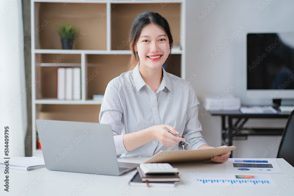 Young asian businesswoman beautiful charming smiling and talking on the mobile phone in the office Young asian businesswoman beautiful charming smiling and talking on the mobile phone in the office