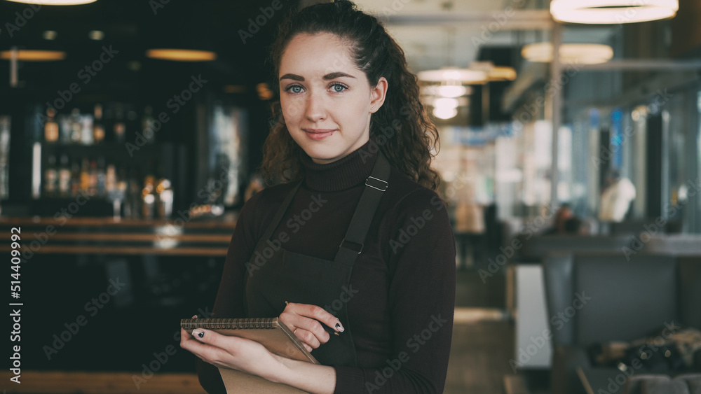 Single Waitress Portrait of cheerful and beautiful young waitress standing, keeping ...