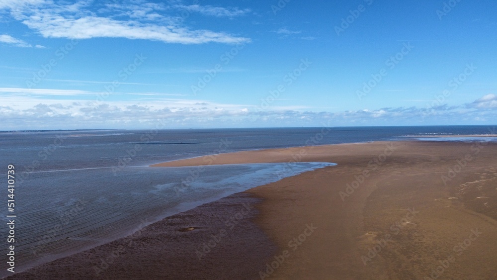 Aerial view of a beach at low tide with the ocean in the distance. Taken in Lytham St Annes Lancashire England. 