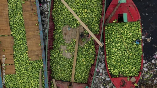 Aerial view of people working on commercial boats with fruits, Buriganga river, Keraniganj, Dhaka, Bangladesh. photo