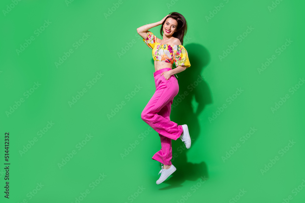 Full length photo of pretty adorable lady wear off shoulders blouse jumping high empty space isolated green color background