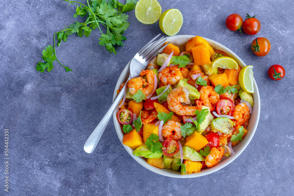 Healthy Shrimp Mango Salad with Avocado, Cherry Tomatoes and Onion, Garnished with Fresh Cilantro

