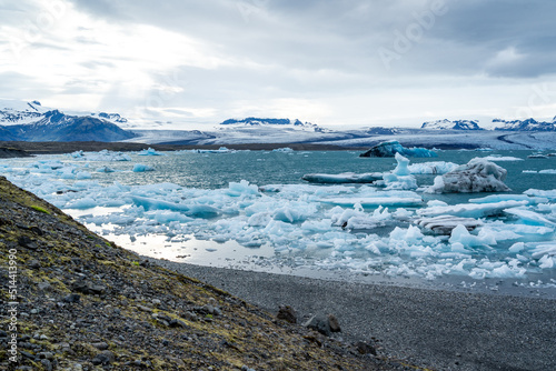 iceberg and floating blocks of ice in glacier lagoon