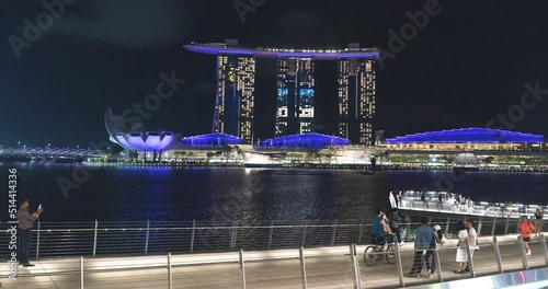 Marina Bay Sands of Singapore viewed from across the lake with Merlion and Artscience museum in frame with the water reflecting. Timelapse, Hyperlapse. Singapore photo