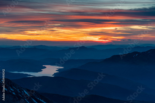 фотография Fiery Sky At Sunset Of The Campotosto Laka From The Top Of Gran Sasso Of Italy