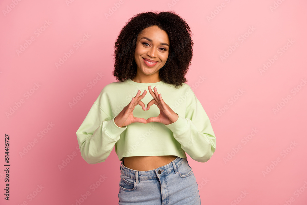 Photo of young pretty woman show fingers heart symbol romantic cupid isolated over pink color background Photo of young pretty woman show fingers heart symbol romantic cupid isolated over pink color background