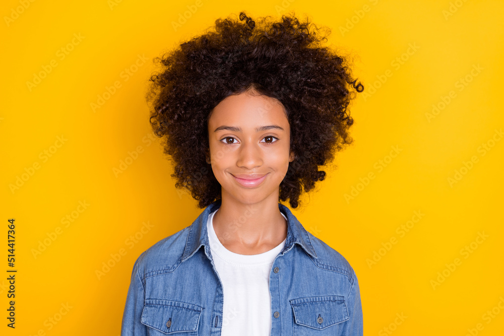Portrait of attractive cheery brunet cute wavy-haired girl bushy hairdress isolated over bright yellow color background Portrait of attractive cheery brunet cute wavy-haired girl bushy hairdress isolated over bright yellow color background