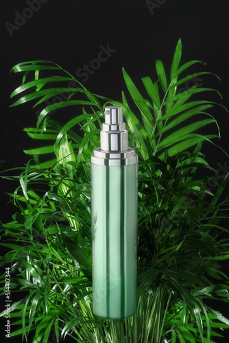 Dark background with green shiny bottle cosmetic packaging on palm leaves, tropical backdrop. Natural skin care product template. Mockup beauty product concept with copy space for your design.