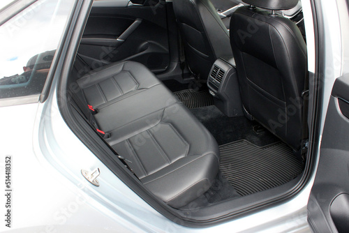 Comfortable black leather car soft clean rear seat. Black Leather interior design, car passenger clean, angle view side. Back passenger seats in modern comfortable car.