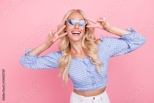 Photo of cheerful funny lady wear off shoulders top dark glasses showing two thumbs isolated pink color background