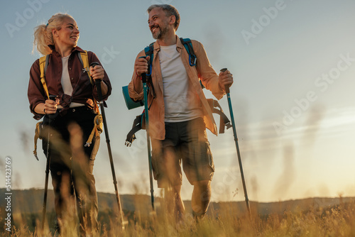 Obraz na płótnie Smiling middle age couple hiking together