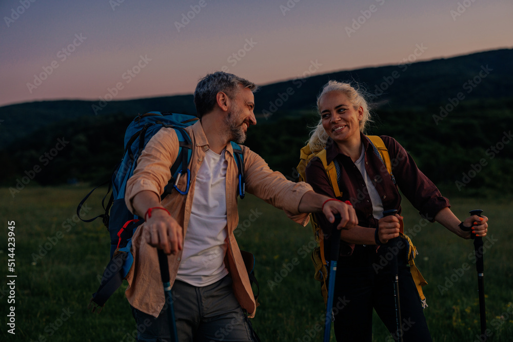 Mid adult couple hiking together out in the mountains Mid adult couple hiking together out in the mountains