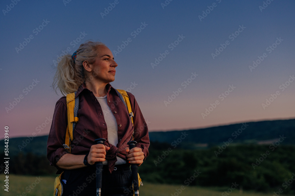 Mature woman hiking through the mountains