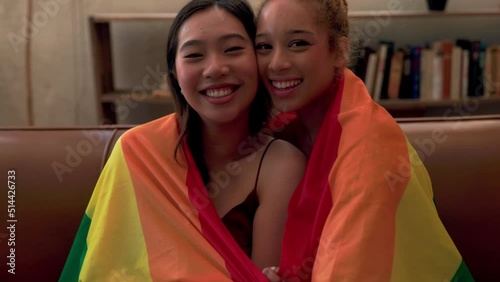 Smiling bisexual couple with pride flag photo