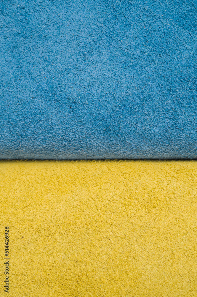 Fototapeta premium A roll of blue and yellow leather. Ukrainian leather production. Factory for sewing shoes in Ukraine